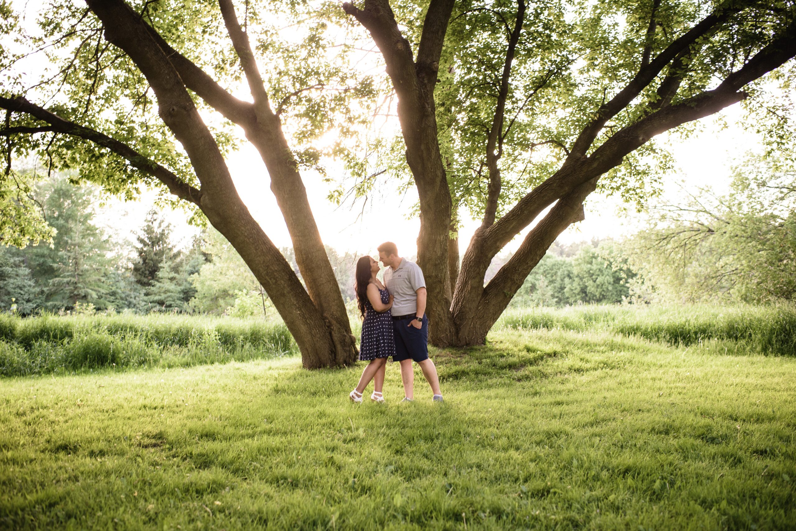 engagement session in a park by big trees